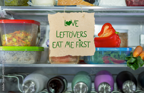 Love Leftovers Eat Me First handmade sign in fridge,  help reduce food waste, know where to look first, simple reduce food waste concept. photo