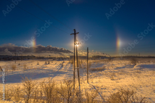 the rainbow halo glows beautifully in the sky on a frosty winter day