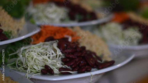 closeup portos cabbage carrot and rice salad in slow motion photo