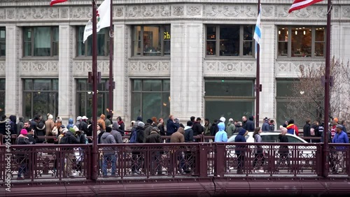 Cold Day in Chicago but people crossing busy bridge. Crowded Sidewalk in Chicago
