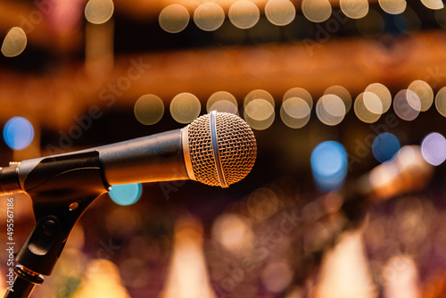 Close up of microphone on the theater stage in concert hall and blurred lights background