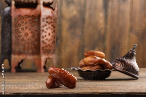 Ramadan Kareem and iftar Muslim holiday concept. Dried dates and lanterns with candles.