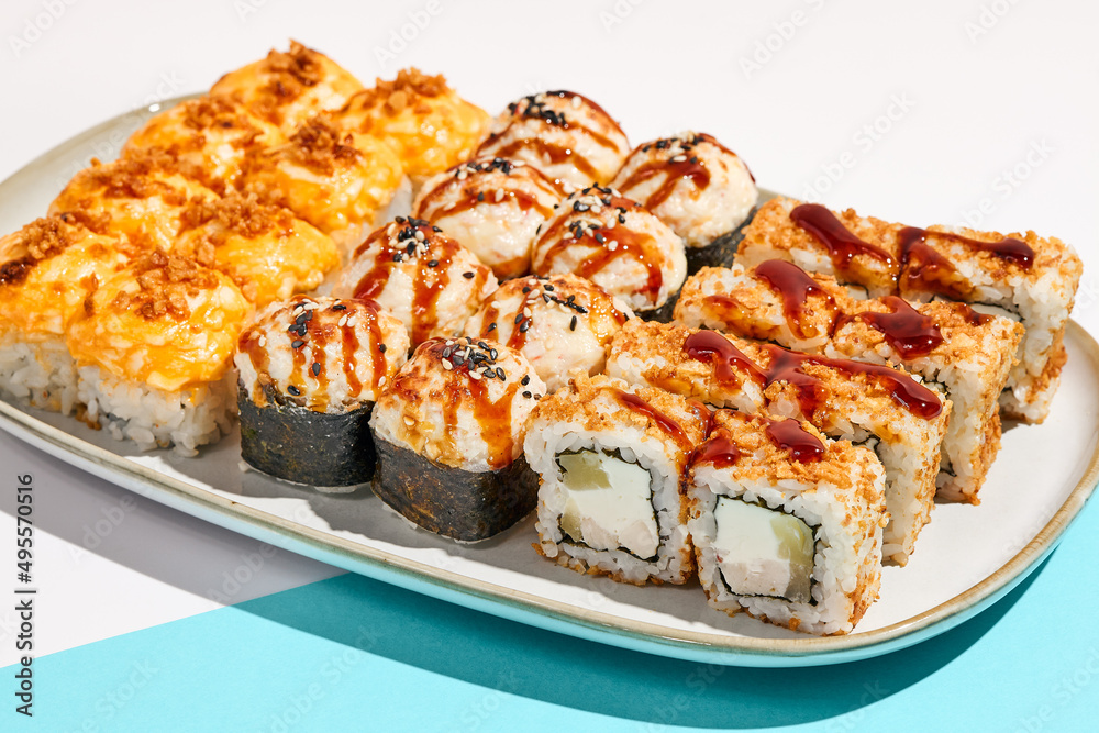 Set of hot maki sushi on ceramic dishware. Baked sushi set in minimal style. Tempura rolls in modern concept. Japanese menu in modern style. Set of hot maki sushi on ceramic dishware. Baked sushi set in minimal style. Tempura rolls in modern concept. Japanese menu in modern style.