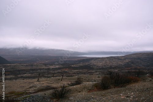 Beautiful mountain scenery in the fog. Old abandoned huge coal pit. Ruins and huge mountains of dirty rock. 