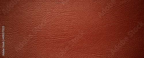 Photo of a rectangular-shaped texture of red genuine leather. Luxury leather background.
