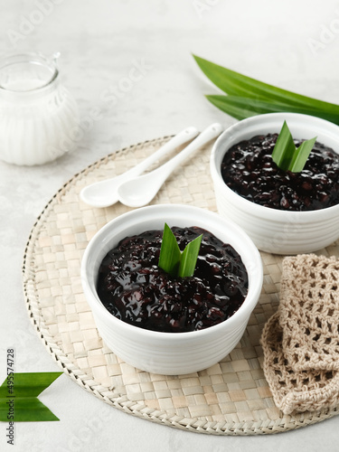 Bubur Ketan Hitam  Indonesian dessert. Black glutinous rice porridge with coconut milk  sugar and pandan leaf. Blurred background and selective focus.