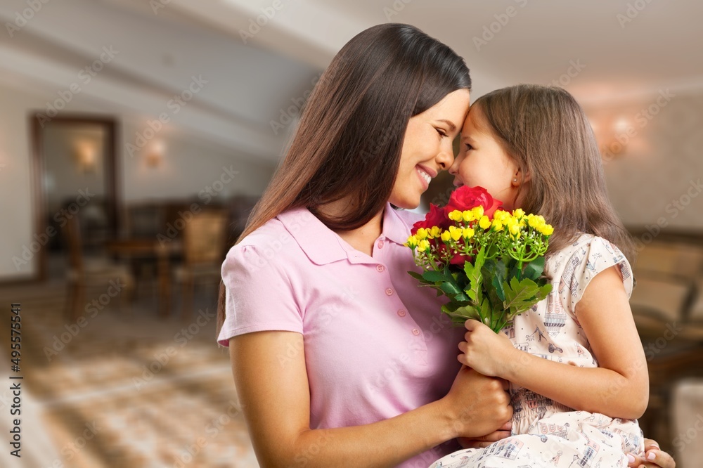 Happy woman child with tulips smiling with eyes. celebrating holiday at home Happy woman child with tulips smiling with eyes. celebrating holiday at home
