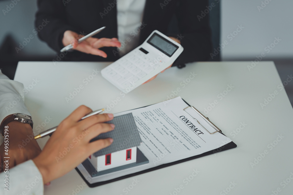 Banker or Agent calculate price for buy or loan house and showing to customer. Real Estate concept. Banker or Agent calculate price for buy or loan house and showing to customer. Real Estate concept.