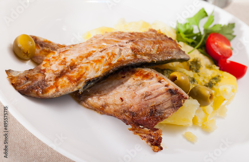 Delicious fried mackerel fillets with mashed potatoes, olives and tomatoes. High quality photo