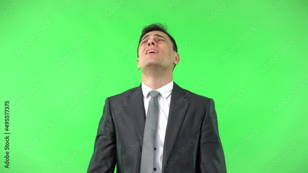 Shocked man in elegant suit looking at camera