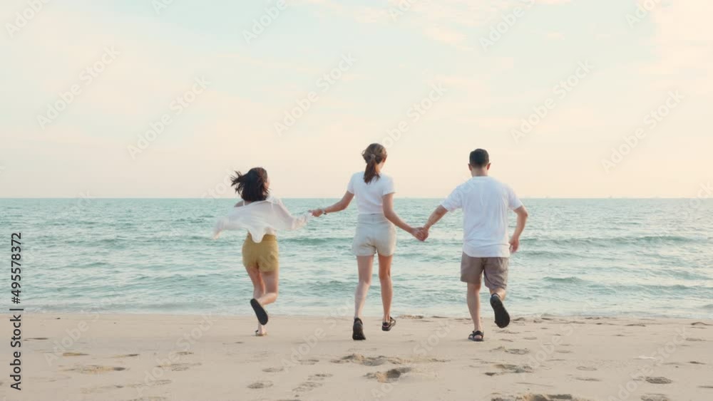 Happy friends holding hands running enjoy life funny and freedom on sand at beach together to sea in holiday vacation time at sunset, Young Asian group woman and man in summer travel, people lifestyle Happy friends holding hands running enjoy life funny and freedom on sand at beach together to sea in holiday vacation time at sunset, Young Asian group woman and man in summer travel, people lifestyle