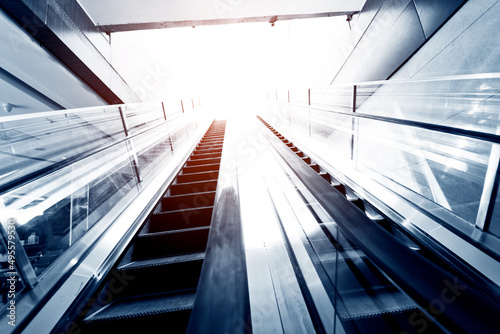 Escalator in business center leading to light