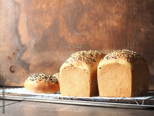 Fotografie, Obraz Bread loaf and rolls with sesame topping
