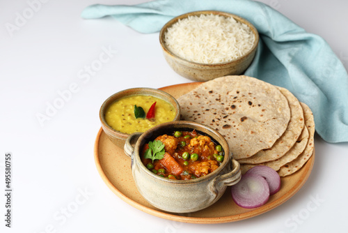 vegetarian Indian thali or Indian home food with lentil dal  cauliflower curry  roti or Indian flat bread and rice