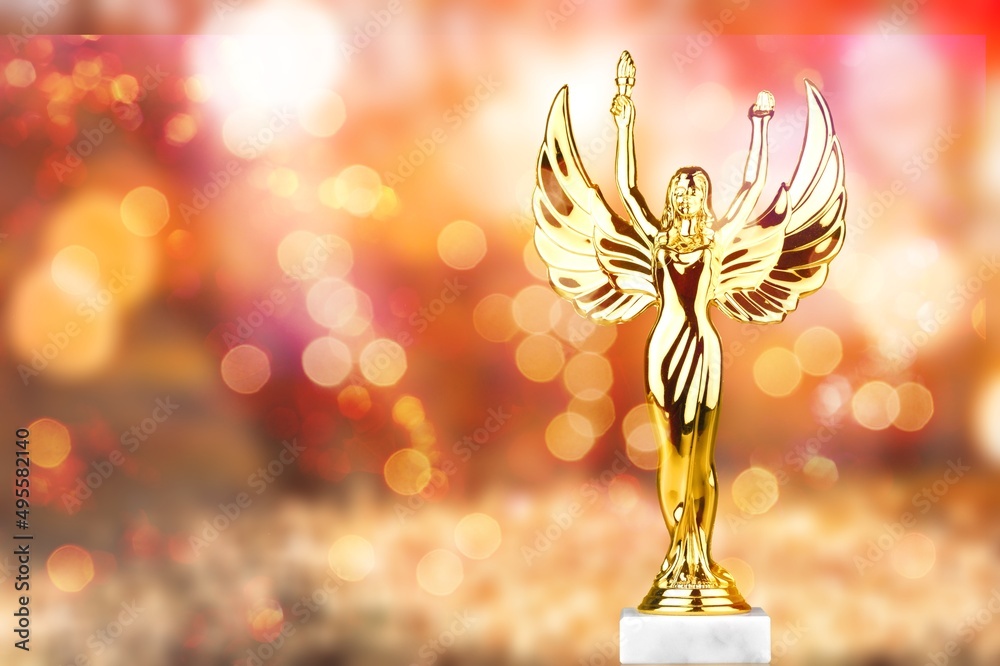 Fototapeta premium Hollywood Golden Academy award statue on fireworks background. Success and victory concept.