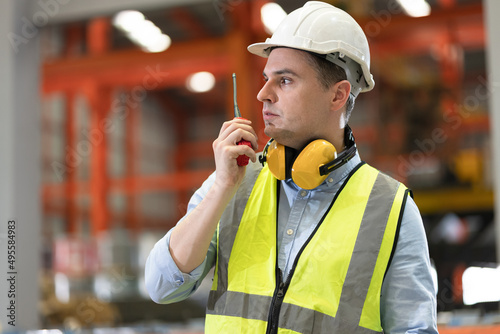 Portrait engineer, mechanic use walkie talkie with machine at factory 