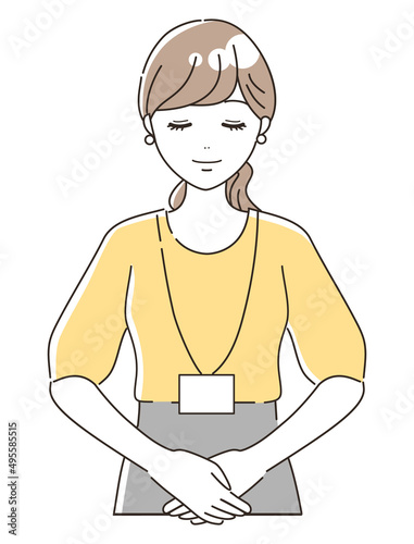 お辞儀をして挨拶をするカジュアルな女性オフィススタッフ（上半身）