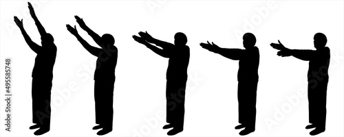 An elderly woman is standing half sideways. Two hands are at the top. The two hands of a person are smoothly lowered. Sport. Warm-up for older people. Movement with both hands from top to bottom. 