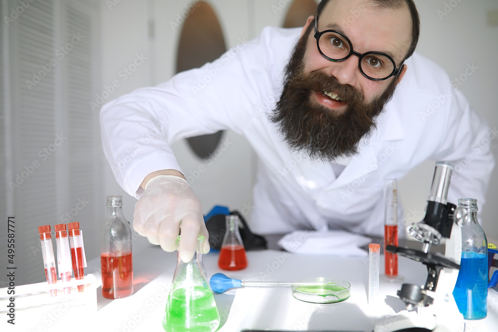 Chemist crazy. A mad scientist conducts experiments in a scientific laboratory. Performs research using a microscope. Chemist crazy. A mad scientist conducts experiments in a scientific laboratory. Performs research using a microscope.