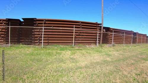 Slow pan of material stockpile for building the border wall between Texas USA and Mexico; near McCallen Texas; concepts of national defense, border security, and Trump's build the wall