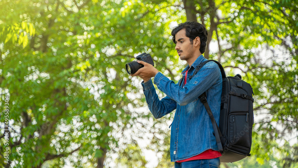 Young photographer checking photos in the camera