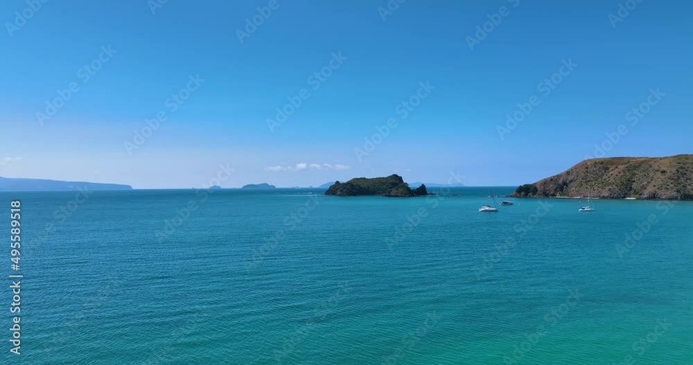 Fly from Opito Bay towards Rabbit Island tranquil azure sea - New Zealand Fly from Opito Bay towards Rabbit Island tranquil azure sea - New Zealand