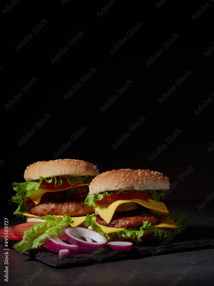 Fresh delicious burger on a dark background Fresh delicious burger on a dark background