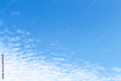 White clouds on bright blue sky background and vast space