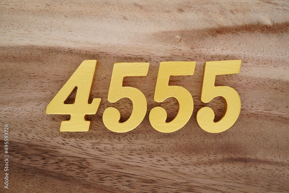 Golden Arabic numerals on a real brown and white wooden floor number ...