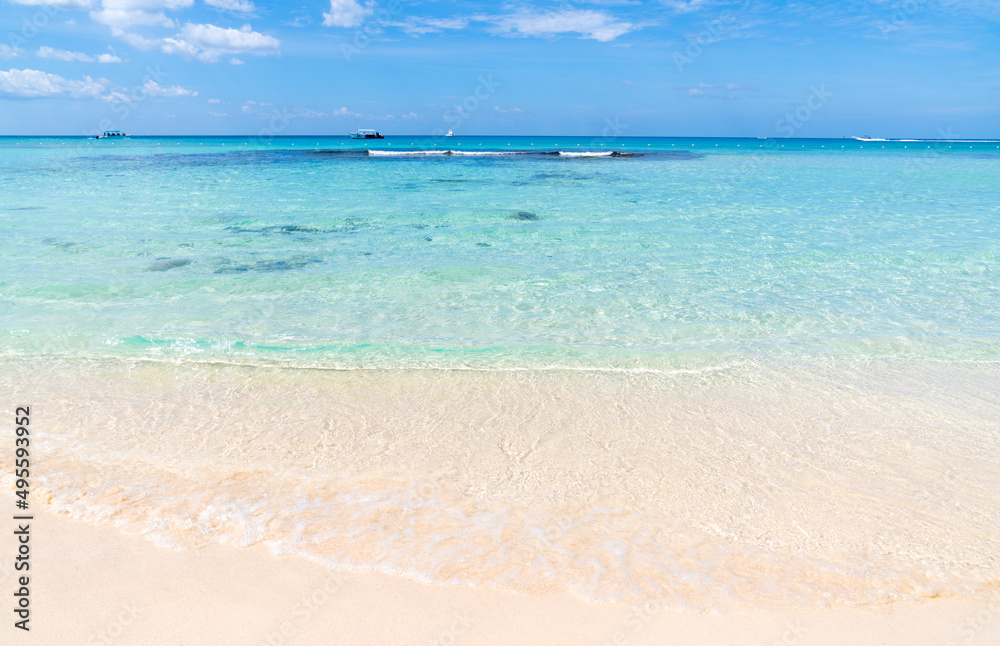 Quiet calm transparent sea and a snow-white beach against a beautiful blue sky. Caribbean coast of the Dominican Republic