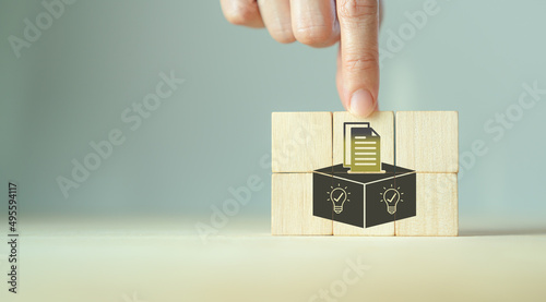 Suggestion and feedback concept. New idea, solution. Wooden cubes with suggestion box, card holder icon on grey background. Business review, strategy suggestion, comment for business developement. photo