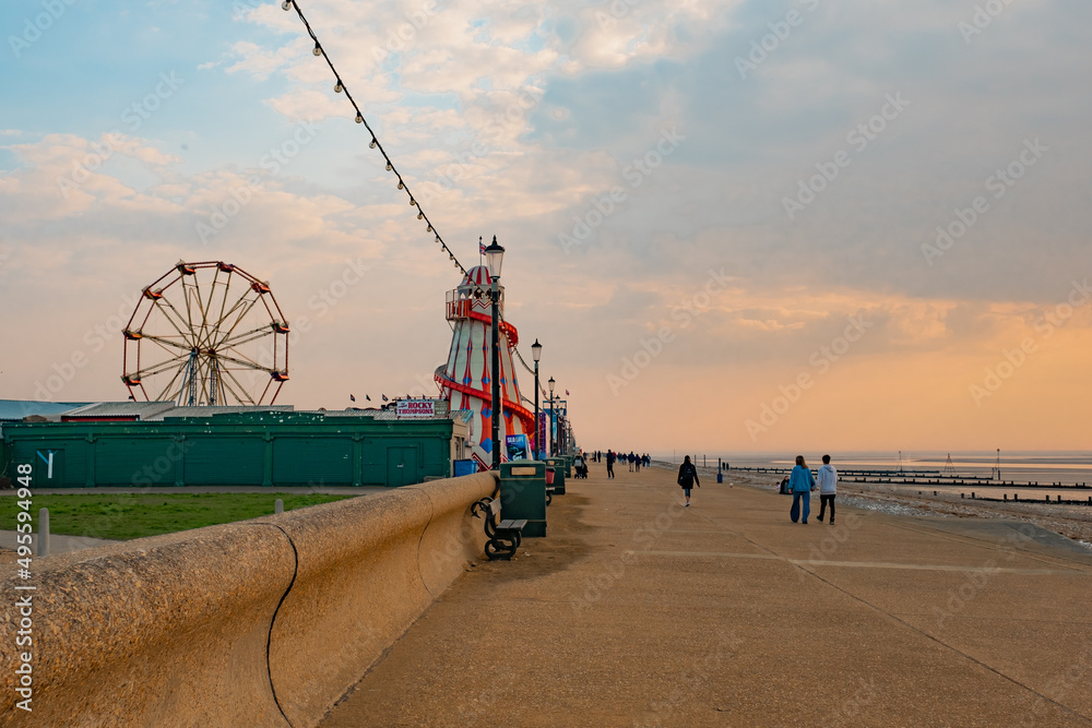 A view down the promenade or esplanade at sunset in the seaside town of Hunstanton on the North Norfolk coast - obrazy, fototapety, plakaty 