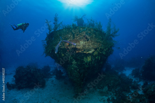 A scuba diver explores a sunken shipwreck in The Bahamas, Long Island, Caribbean