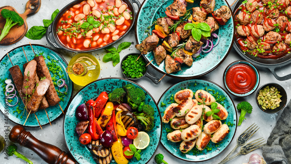Food background. Set of traditional Turkish and Oriental cuisine. Set of meat and vegetable dishes in plates. Top view. On a stone background.