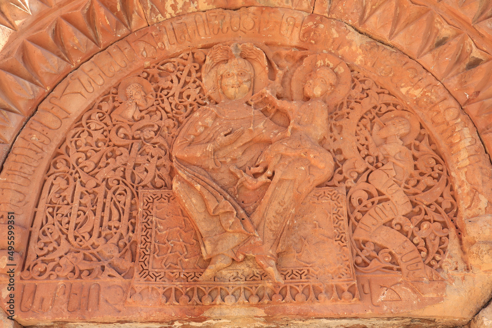 Decorative sculpture above the entrance door with Vergin Mary and baby Jesus in Noravank, Armenia