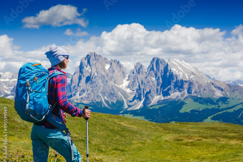 happy woman hiker standing with mountain ridge background. The woman is happy. Travel and active lifestyle concept