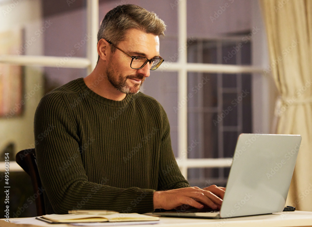 Focused on getting his business up and running. Cropped shot of a handsome mature businessman working on his laptop at home. Focused on getting his business up and running. Cropped shot of a handsome mature businessman working on his laptop at home.