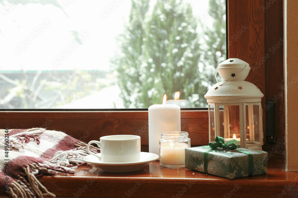 Composition of cozy winter day on wooden windowsill