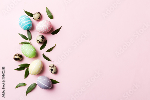 Colorful Easter eggs with spring flower leaf isolated over white background. Colored Egg Holiday border