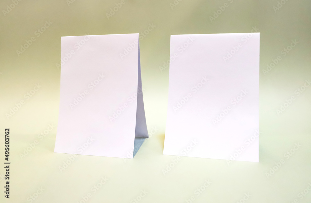 A6 A5 A4 Portrait tent fold mockup. White sheet mockup on green background. A6 A5 A4 Portrait tent fold mockup. White sheet mockup on green background.