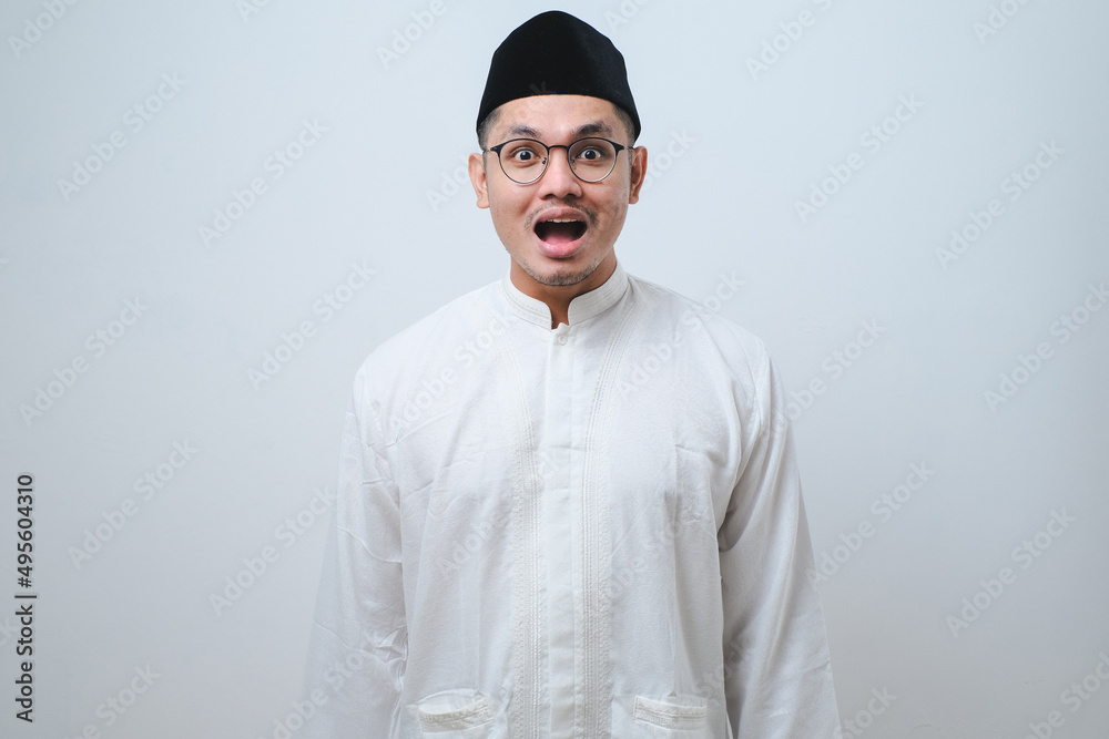 Asian muslim man shocked gesture can not believe of what he sees