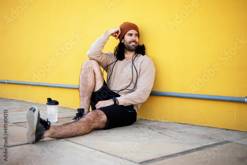 Young muscle man training outside. Fit handsome man resting after training