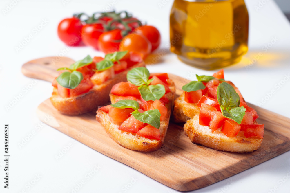 Italian tomato and cheese bruschetta. Tapas, antipasti with chopped vegetables, herbs and oil on grilled ciabatta and baguette bread. Italian tomato and cheese bruschetta. Tapas, antipasti with chopped vegetables, herbs and oil on grilled ciabatta and baguette bread.