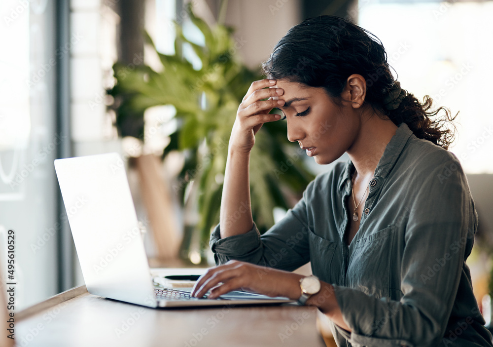 Stress management is a must for solo entrepreneurs. Shot of a young woman experiencing stress while working in a cafe . Stress management is a must for solo entrepreneurs. Shot of a young woman experiencing stress while working in a cafe .