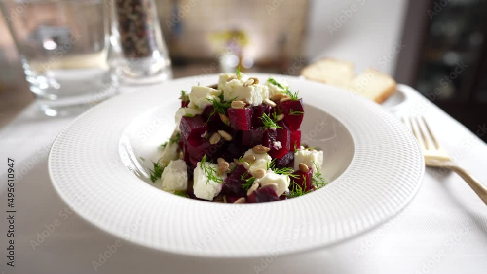 Healthy salad with beetroot, feta cheese and sunflower seeds in white plate, close up, rotates Healthy salad with beetroot, feta cheese and sunflower seeds in white plate, close up, rotates