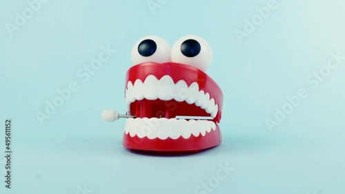 Сhattering teeth toy on blue background