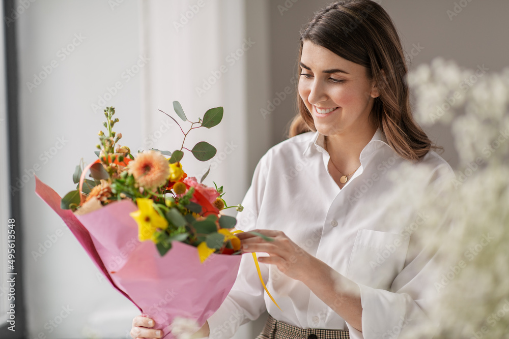 people, gardening and floral design concept - happy smiling woman or floral artist with bunch of flowers at home people, gardening and floral design concept - happy smiling woman or floral artist with bunch of flowers at home