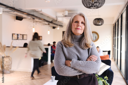 Fotografie Portrait of confident senior white businesswoman with long gray hair looking at