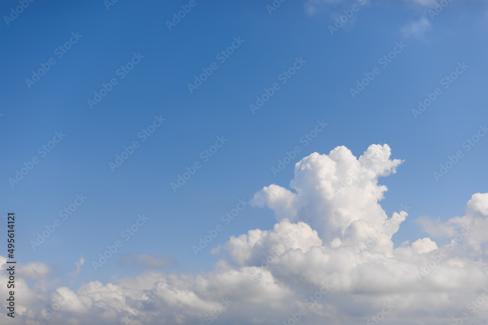 Morning subtle blue sky background with a huge shapeless cumulus cloud Morning subtle blue sky background with a huge shapeless cumulus cloud