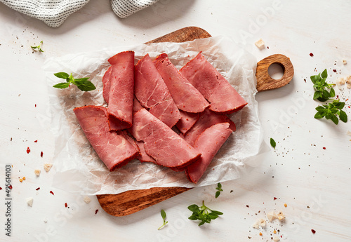 Beef pastrami slices on cutting board